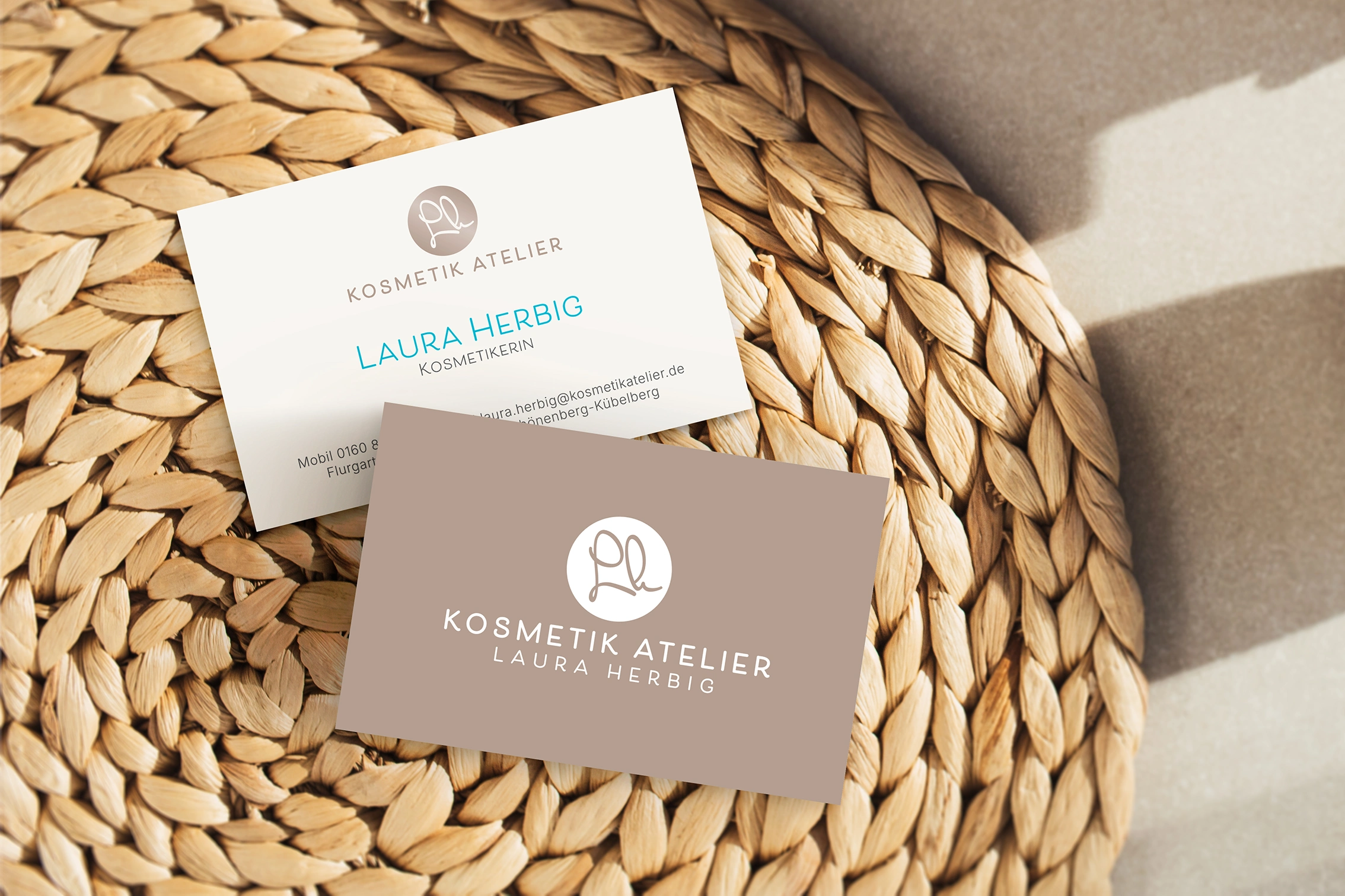 Visitenkarten für Kosmetik Atelier Laura Herbig mit femininem Corporate Design in Naturfarben auf geflochtener Unterlage.